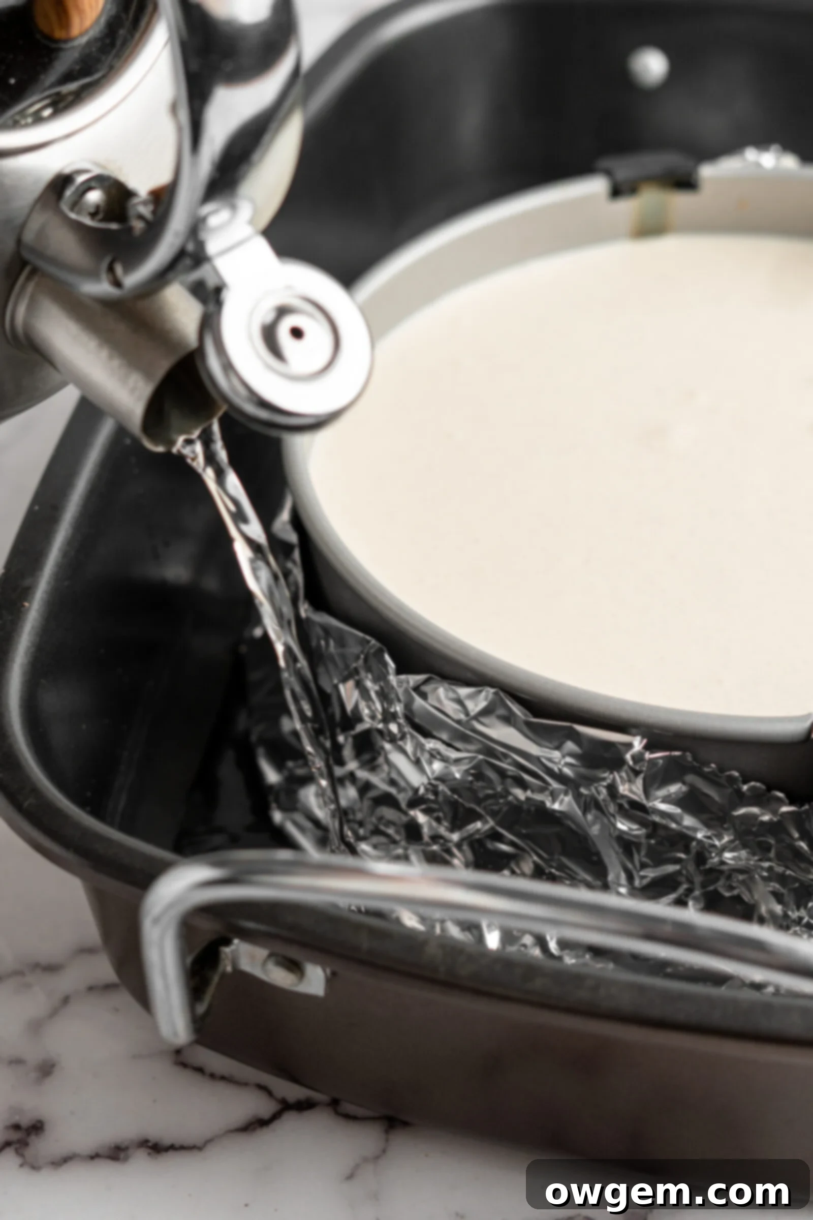 pouring hot water for cheesecake water bath