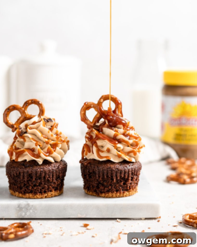 A beautiful array of freshly baked SunButter Pretzel Chocolate Cupcakes cooling on a wire rack, showcasing their distinct two-layer structure: the dark chocolate cupcake atop the lighter pretzel base.