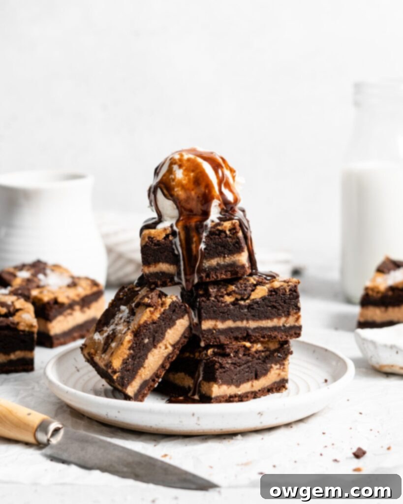 Close-up of a square fudgy peanut butter stuffed brownie with a peanut butter swirl on top, showcasing its gooey center and rich texture.