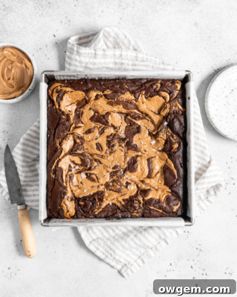 A stack of perfectly cut fudgy peanut butter stuffed brownies, showcasing the distinct layers and swirl.