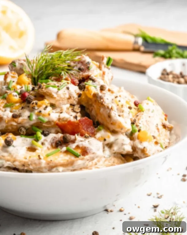 A bowl of creamy warm potato salad, steaming and inviting.