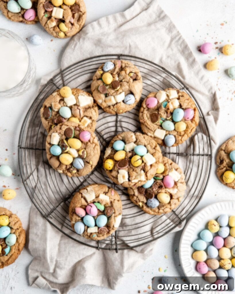 Close-up of a perfectly baked chewy Cadbury Mini Egg Cookie with white chocolate chunks, ready for Easter