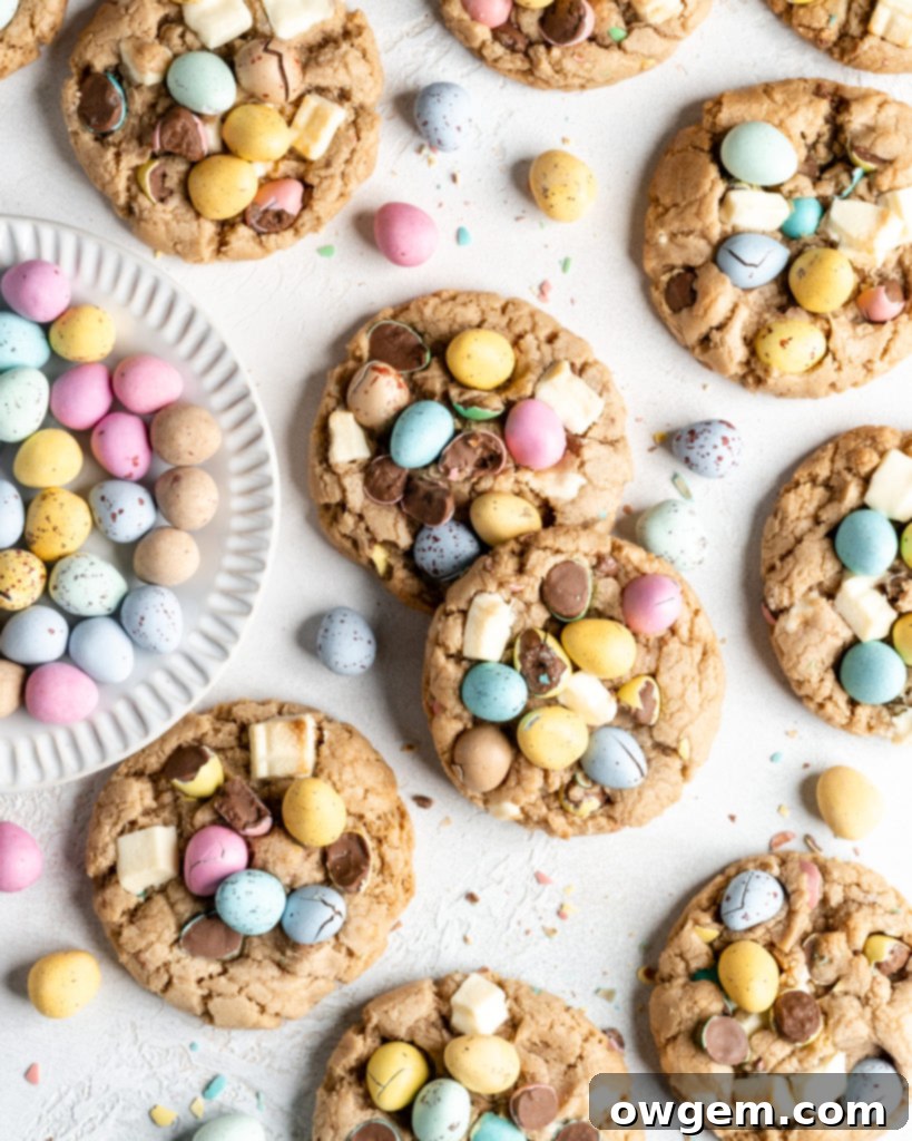 Freshly baked Cadbury Mini Egg Cookies cooling on a wire rack, showing their vibrant colors and crispy edges
