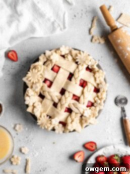 Freshly baked strawberry pie with a thick, jammy filling and a flaky, golden crust, ready to be served.