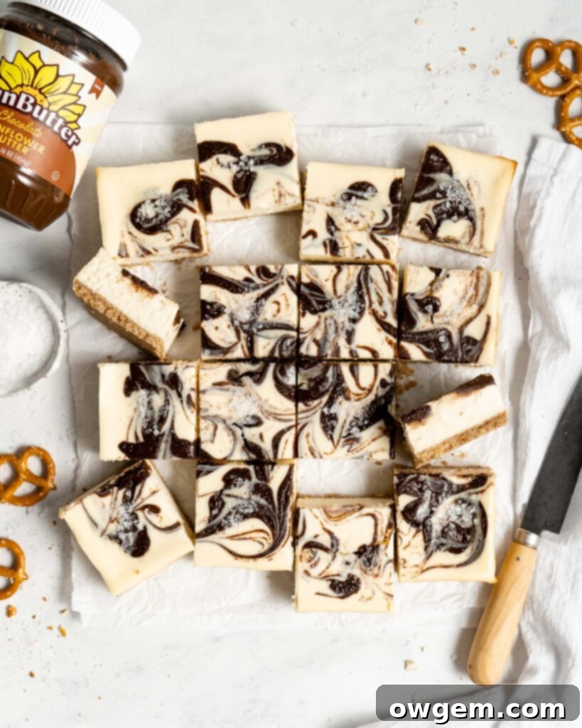 Close-up of a slice of Chocolate SunButter Cheesecake Bar showing the swirl and pretzel crust