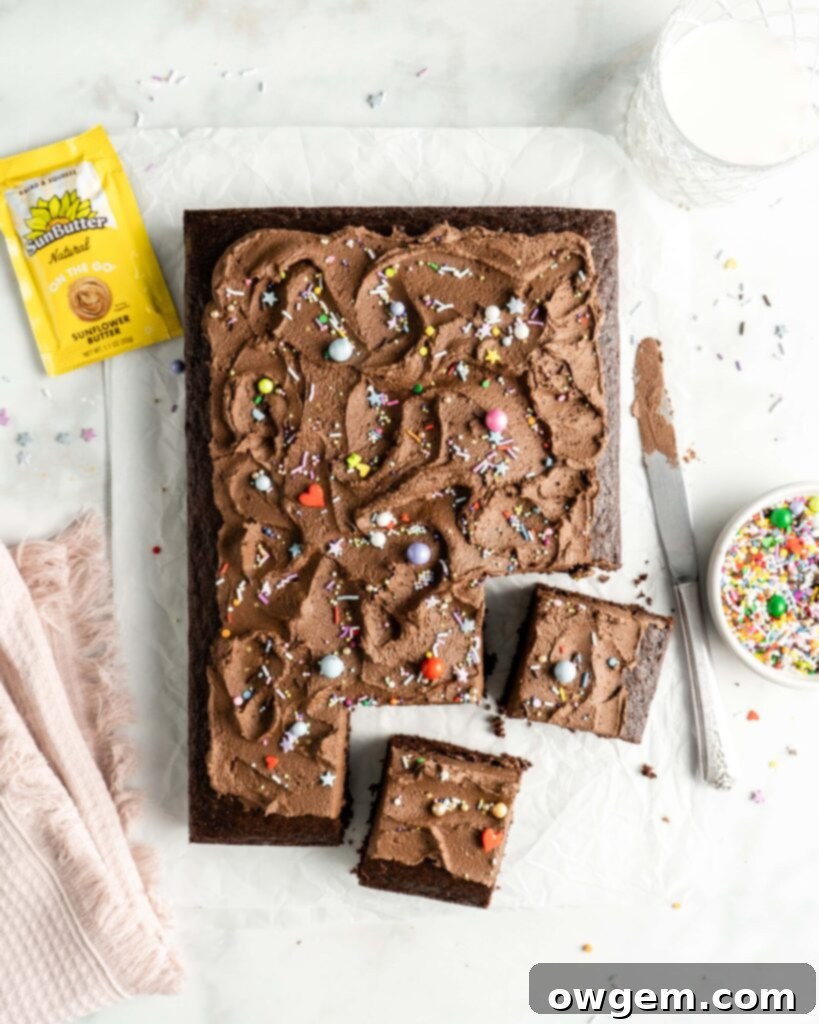 Decadent Chocolate Sheet Cake topped generously with creamy SunButter Chocolate Buttercream and colorful sprinkles, perfect for any celebration.