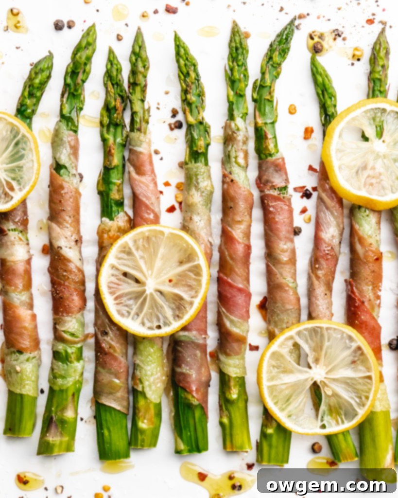 Crispy prosciutto wrapped around fresh green asparagus fresh from the oven