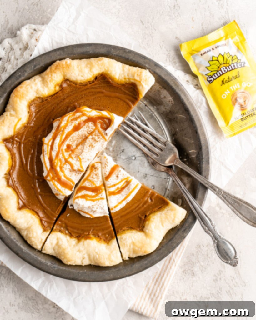 Close-up of SunButter Salted Caramel Pumpkin Pie slice, showing flaky crust and creamy filling