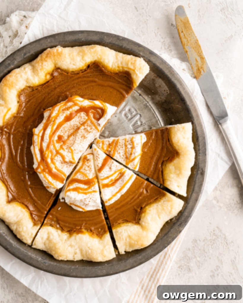 Fully baked SunButter Salted Caramel Pumpkin Pie, garnished with whipped cream and caramel drizzle