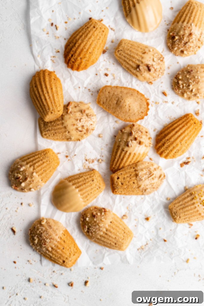close up of maple chai spiced madeleines with glaze and pecans