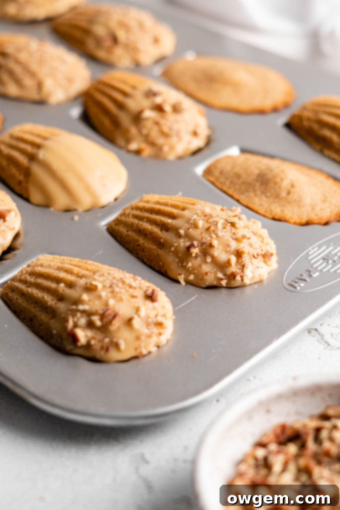 maple chai spiced madeleines dipped in a maple glaze and sprinkled with crushed pecans arranged artfully