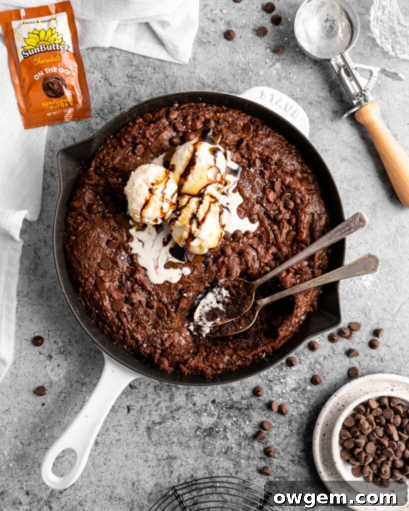 Fudgy SunButter Triple Chocolate Brownie Skillet topped with melting vanilla ice cream