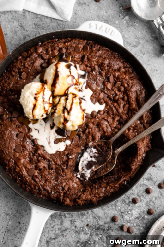 Two servings of SunButter Triple Chocolate Brownie Skillet with vanilla ice cream and chocolate drizzle