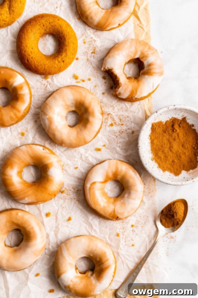 Freshly baked pumpkin spice latte donuts arranged on a cooling rack