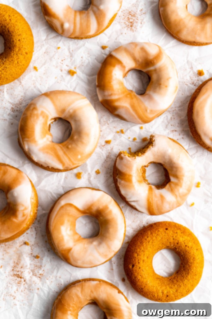 Piping pumpkin spice latte donut batter into a donut pan