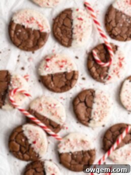 Crinkly fudgy chocolate peppermint brownie cookies dipped in white chocolate and sprinkled with crushed candy canes