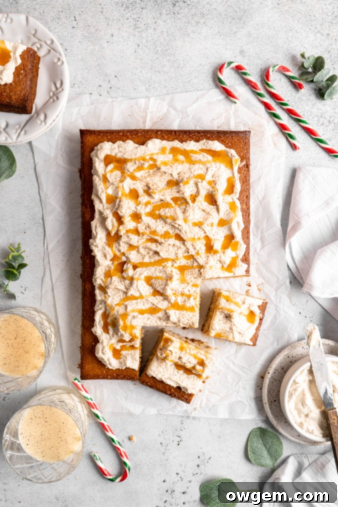 Bourbon Eggnog Sheet Cake with fluffy eggnog frosting, drizzled with caramel sauce
