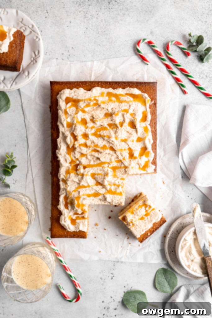 Bourbon Eggnog Sheet Cake with fluffy eggnog frosting, drizzled with caramel sauce