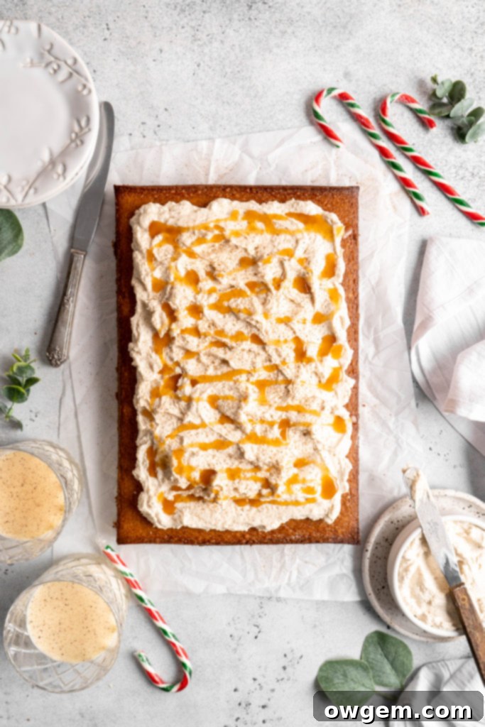 Bourbon Eggnog Sheet Cake with fluffy eggnog frosting, drizzled with caramel sauce