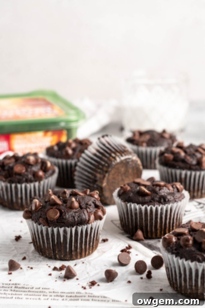 Tall and fluffy Double Chocolate Chip Muffins cooling on a wire rack