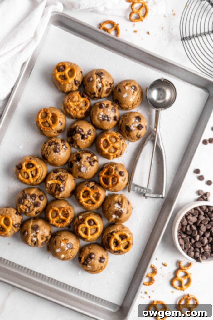 Freshly baked SunButter Toffee Pretzel Cookies on a cooling rack, glistening with melted chocolate