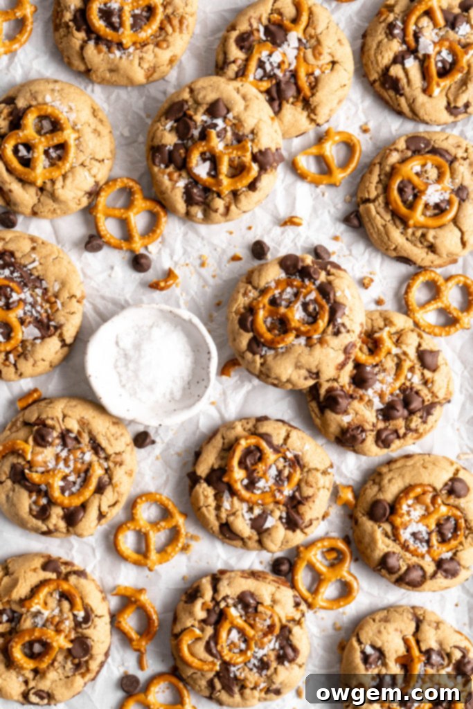 Two halves of a SunButter Toffee Pretzel Cookie revealing its delicious fillings and chewy texture
