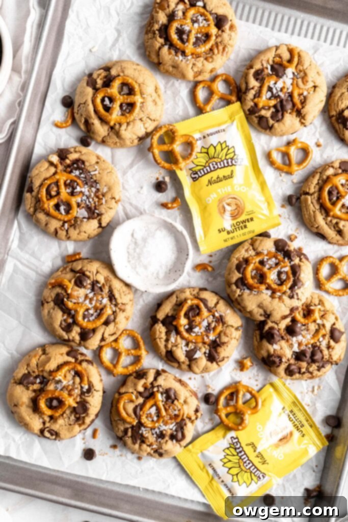 Another view of a SunButter Toffee Pretzel Cookie, highlighting its rich color and toppings
