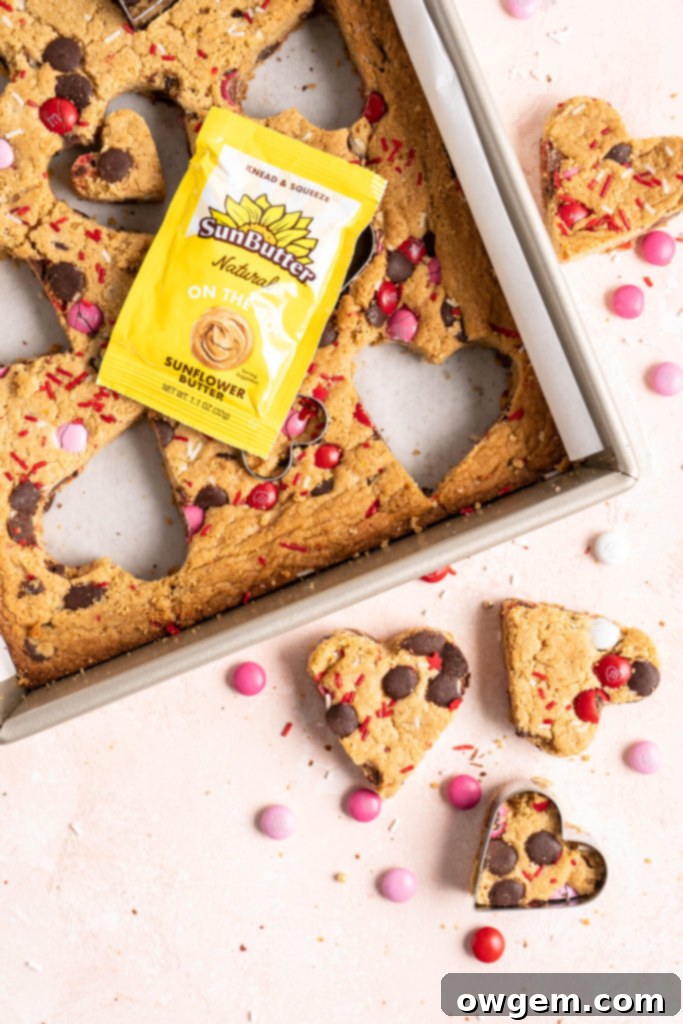 Heart shaped chewy one bowl SunButter m&m blondies on a cooling rack