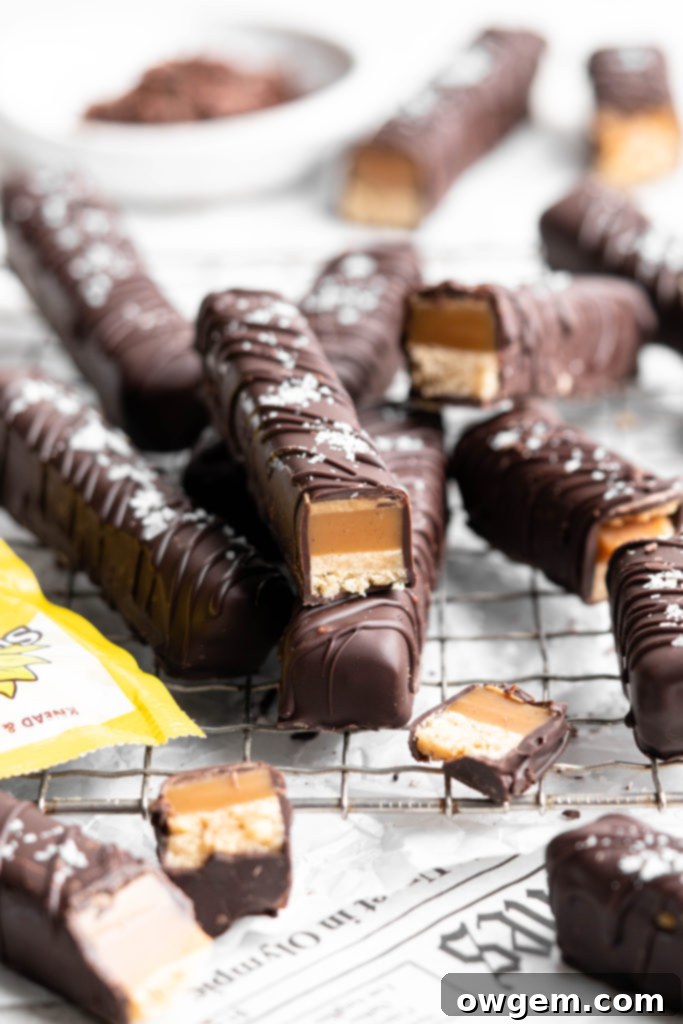 Homemade Twix bars are made with a shortbread layer, a soft caramel layer, a creamy SunButter layer, and coated in dark chocolate