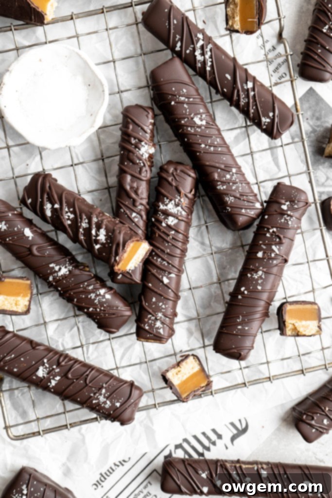 Homemade Twix bars are made with a shortbread layer, a soft caramel layer, a creamy SunButter layer, and coated in dark chocolate