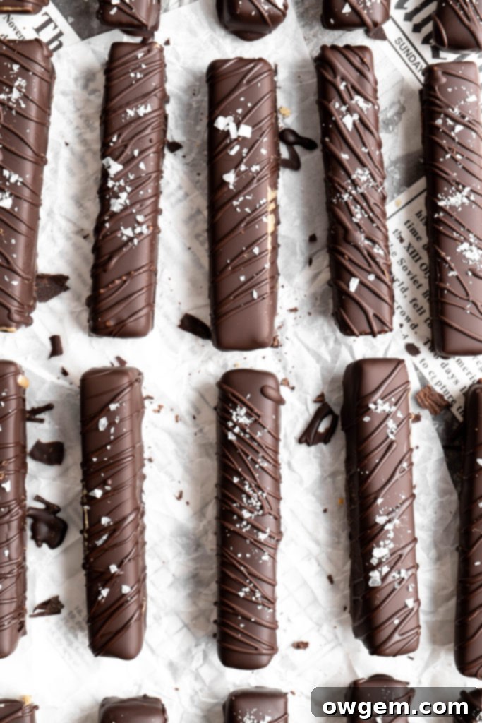 Homemade Twix bars are made with a shortbread layer, a soft caramel layer, a creamy SunButter layer, and coated in dark chocolate