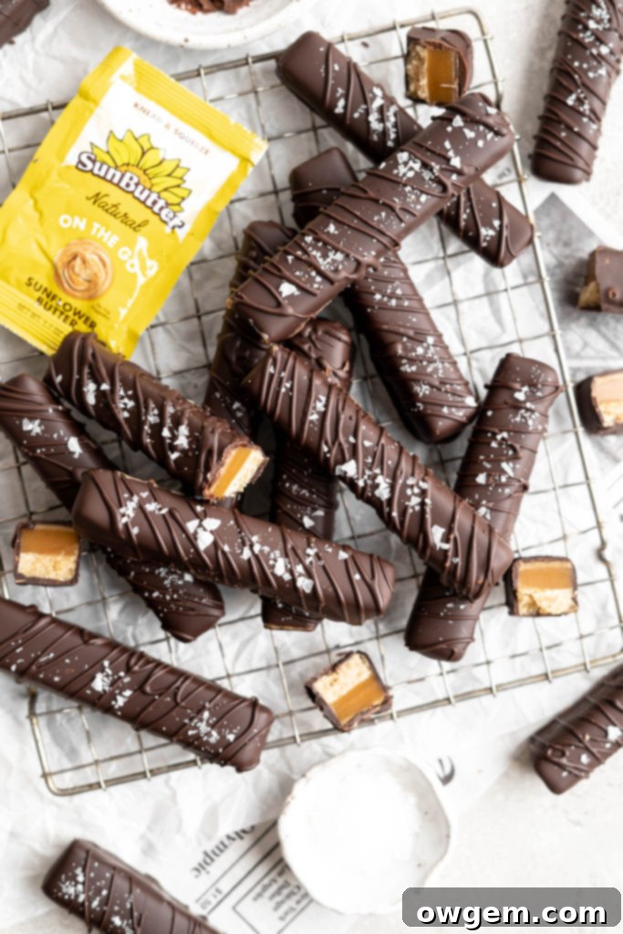 Homemade Twix bars are made with a shortbread layer, a soft caramel layer, a creamy SunButter layer, and coated in dark chocolate