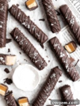 Homemade Twix bars are made with a shortbread layer, a soft caramel layer, a creamy SunButter layer, and coated in dark chocolate