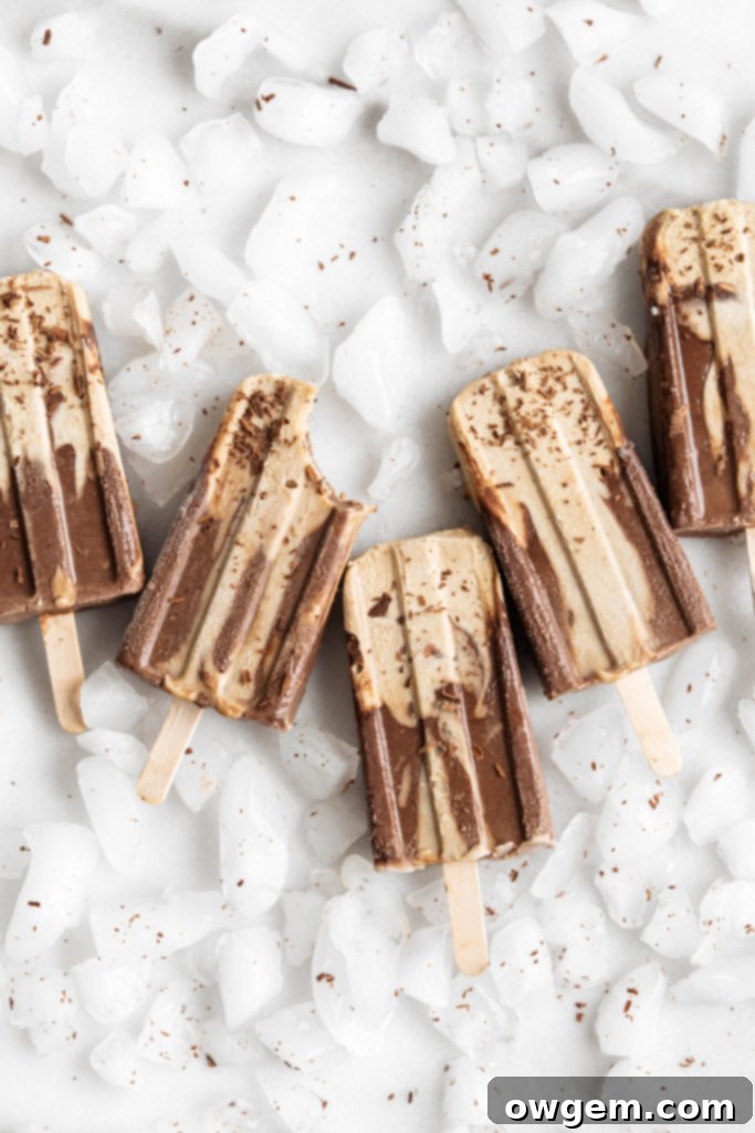 Creamy SunButter Chocolate Fudgesicles cooling on a rack