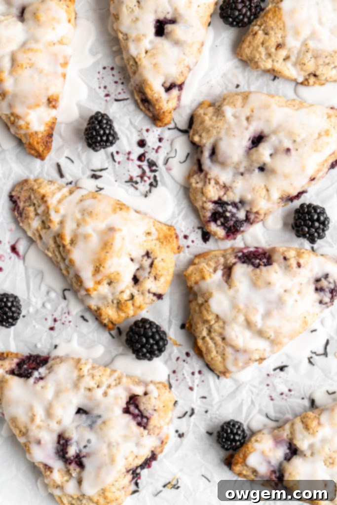 Blackberry Earl Grey scones covered in vanilla glaze, ready to be served