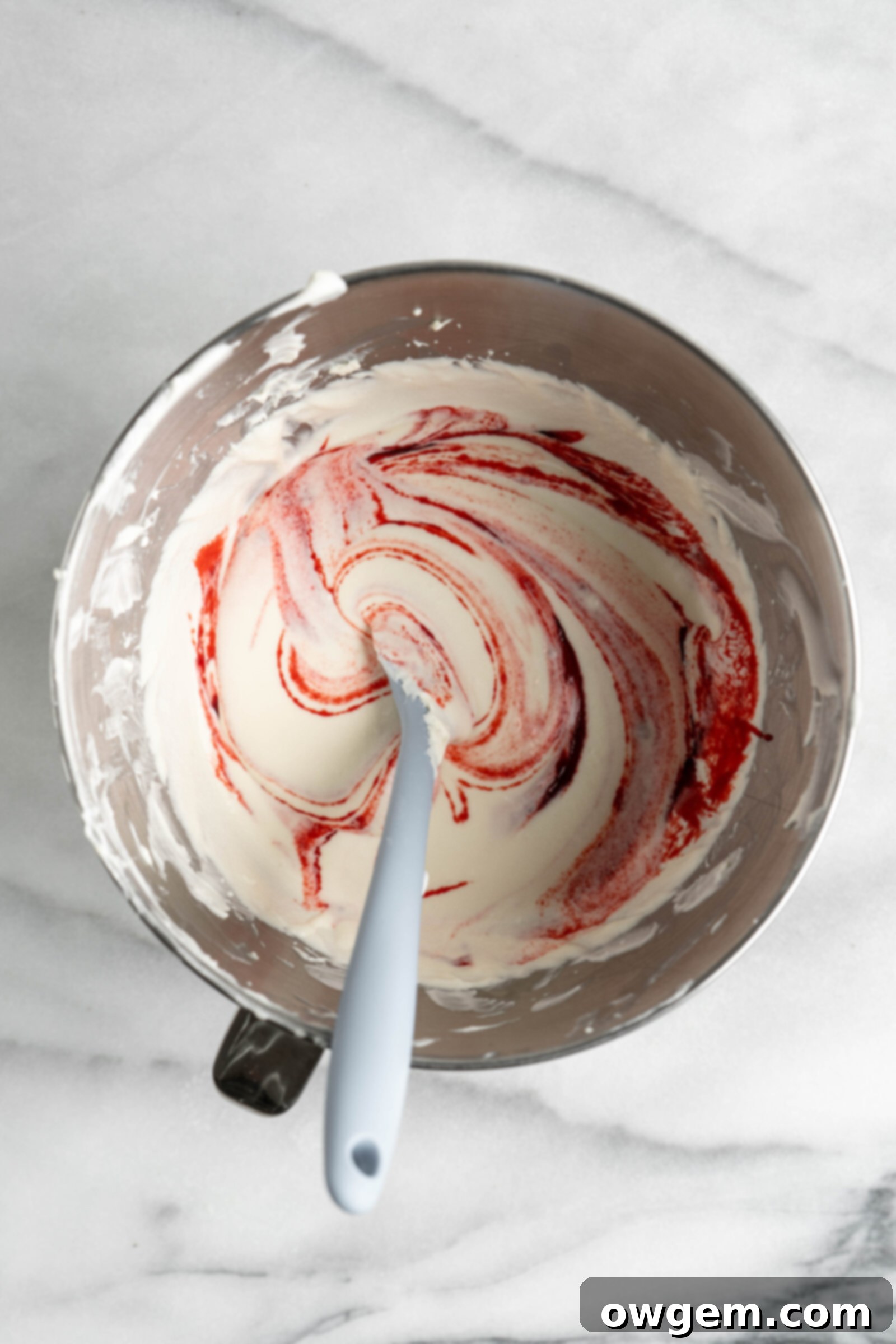 Strawberry jam added to no bake cheesecake filling.