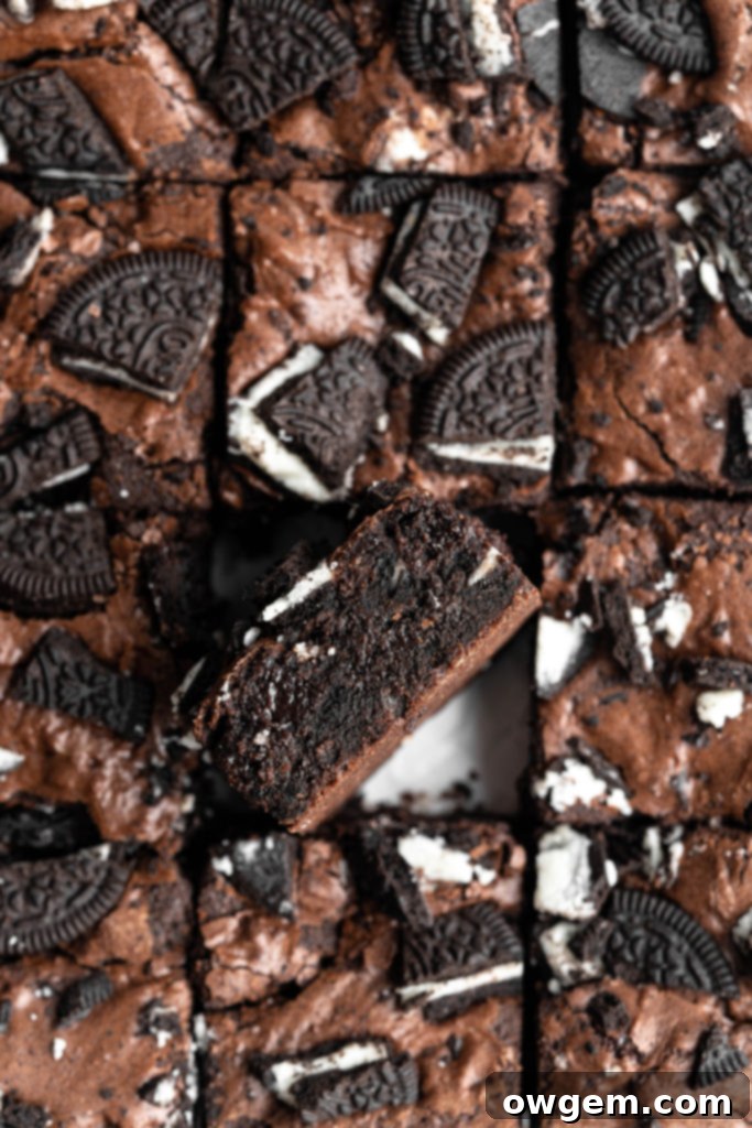 Crinkly top brownies with Oreos on top, one brownie turned on its side, emphasizing the interior texture.