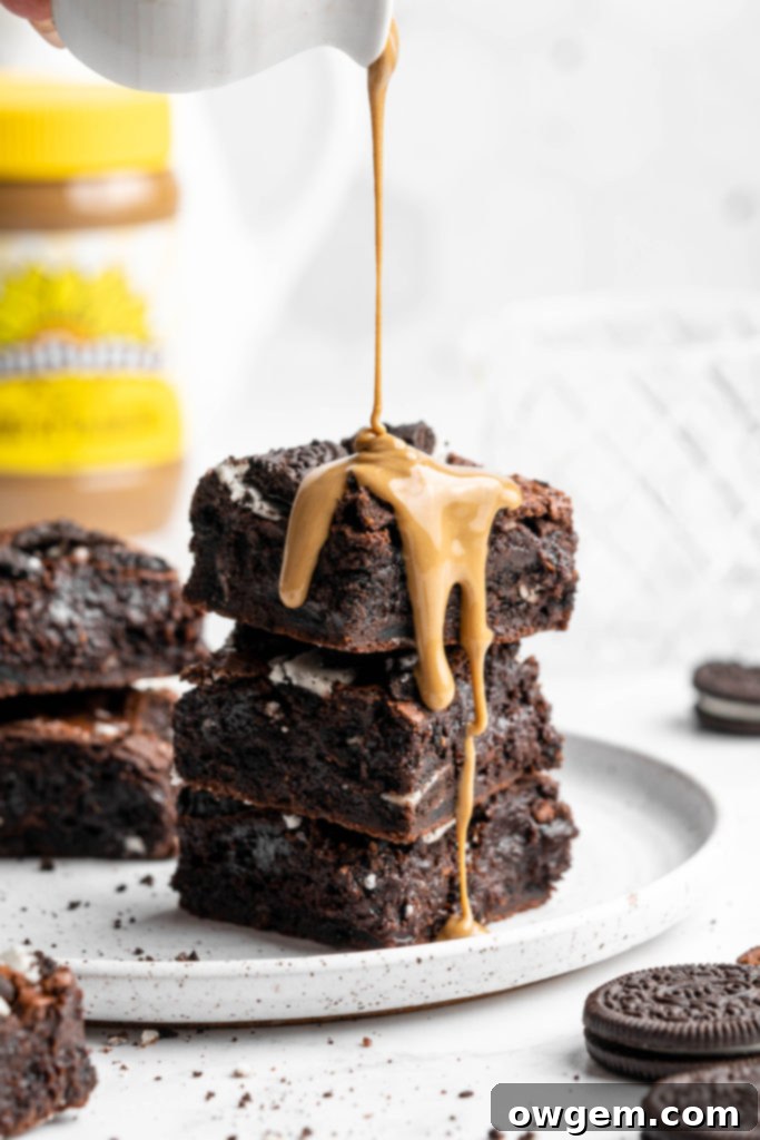 Crinkly top brownies with Oreos on top, beautifully drizzled with SunButter for extra flavor.