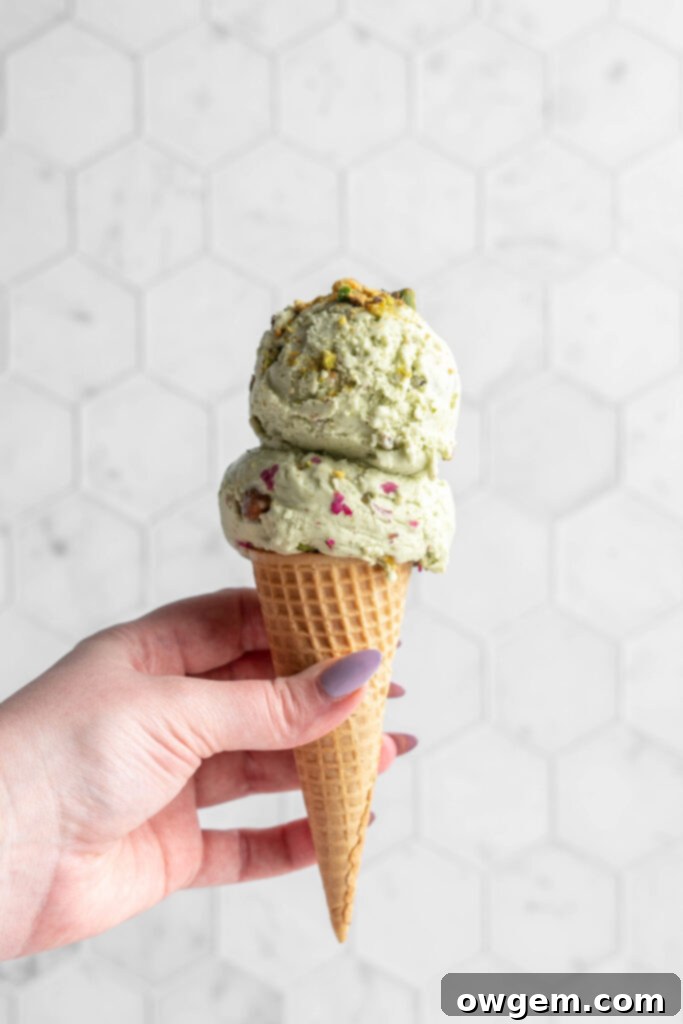 pistachio ice cream scoops in a cone