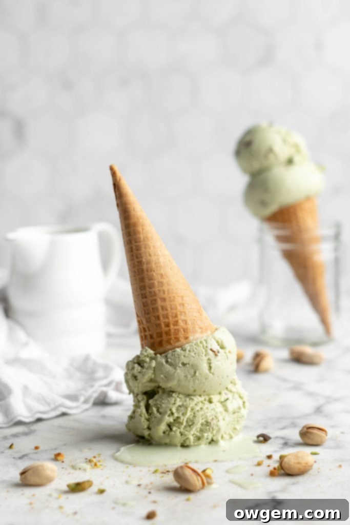 pistachio ice cream scoops in a cone upside down