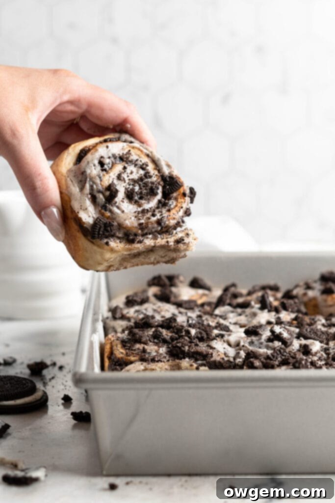 Freshly baked Oreo Cookies and Cream Cinnamon Rolls with melted cream cheese frosting