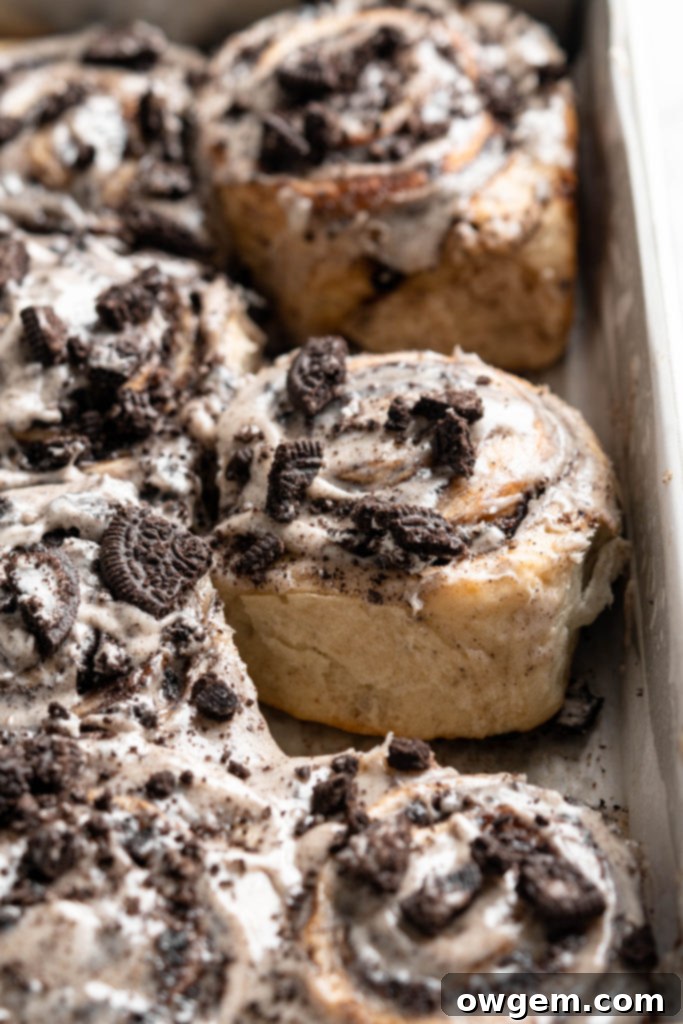 Pile of Oreo Cookies and Cream Cinnamon Rolls on a white plate