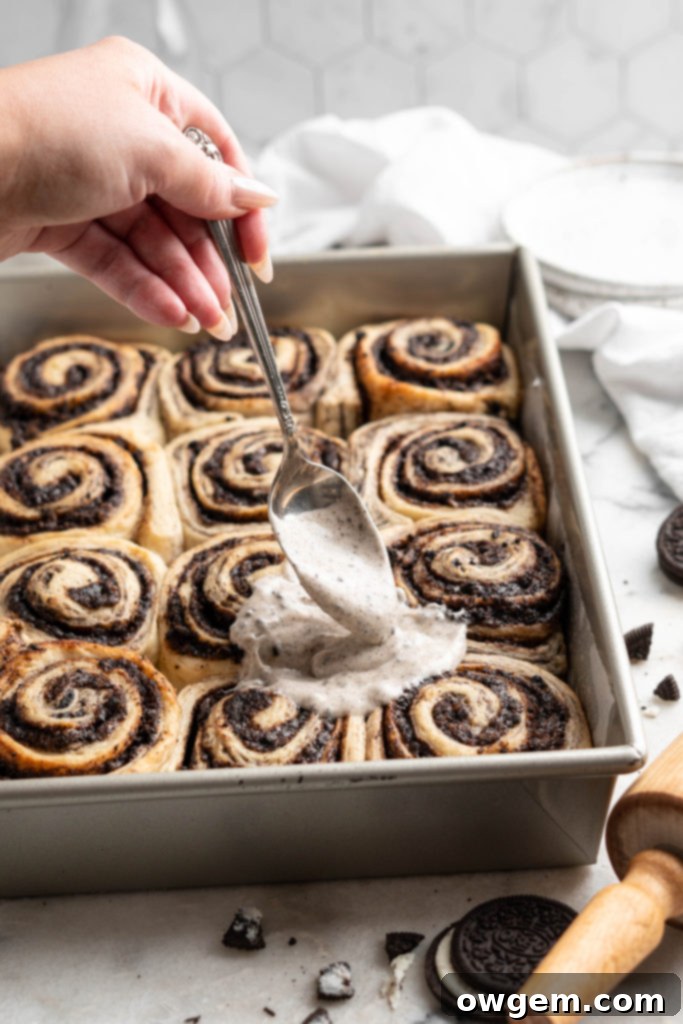 Close-up of a single Oreo Cookies and Cream Cinnamon Roll being picked up
