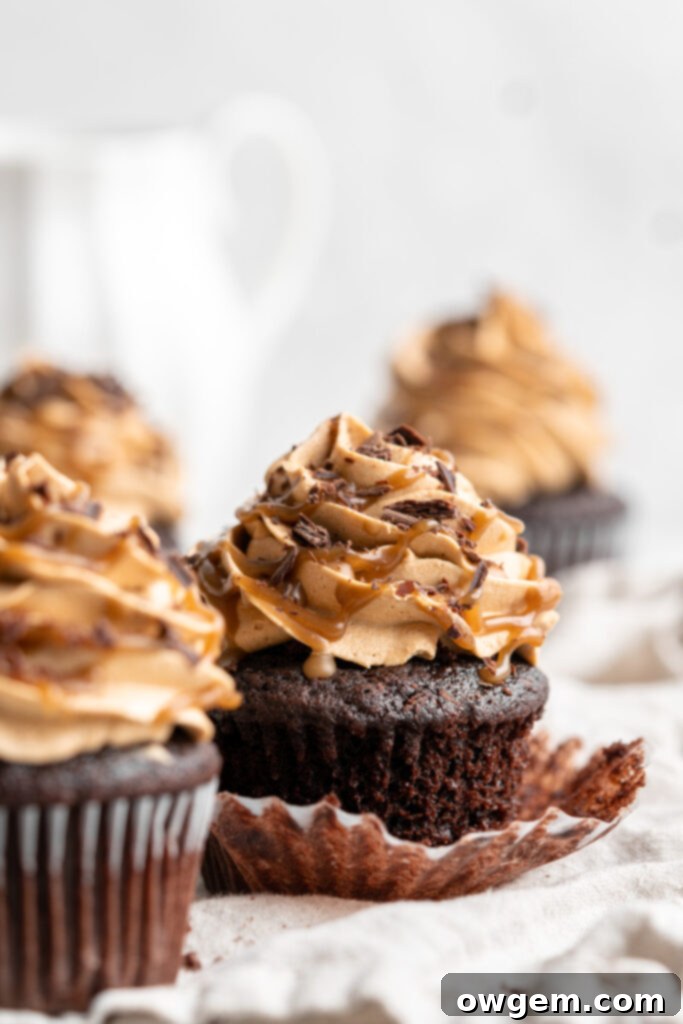 Snicker chocolate cupcakes filled with peanut free SunButter caramel sauce, topped with caramel buttercream, caramel sauce and chocolate shavings