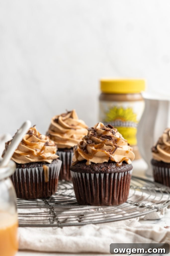 Snicker chocolate cupcakes filled with peanut free SunButter caramel sauce, topped with caramel buttercream, caramel sauce and chocolate shavings