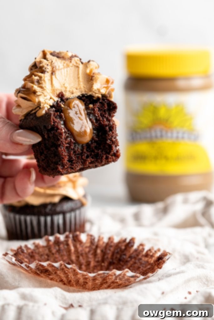 Snicker chocolate cupcakes filled with peanut free SunButter caramel sauce, topped with caramel buttercream, caramel sauce and chocolate shavings