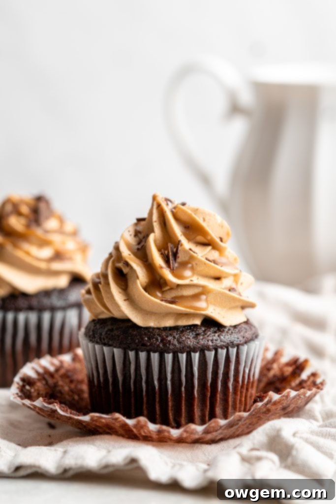 Snicker chocolate cupcakes filled with peanut free SunButter caramel sauce, topped with caramel buttercream, caramel sauce and chocolate shavings