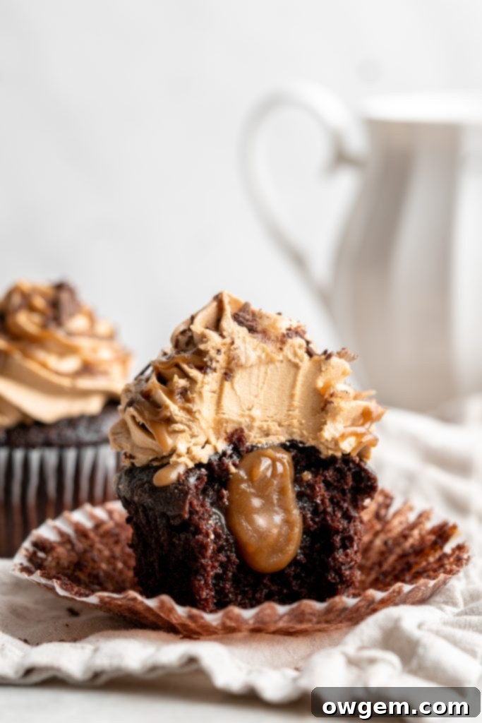 Snicker chocolate cupcakes filled with peanut free SunButter caramel sauce, topped with caramel buttercream, caramel sauce and chocolate shavings