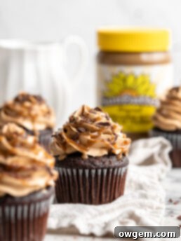 Snicker chocolate cupcakes filled with peanut free SunButter caramel sauce, topped with caramel buttercream, caramel sauce and chocolate shavings