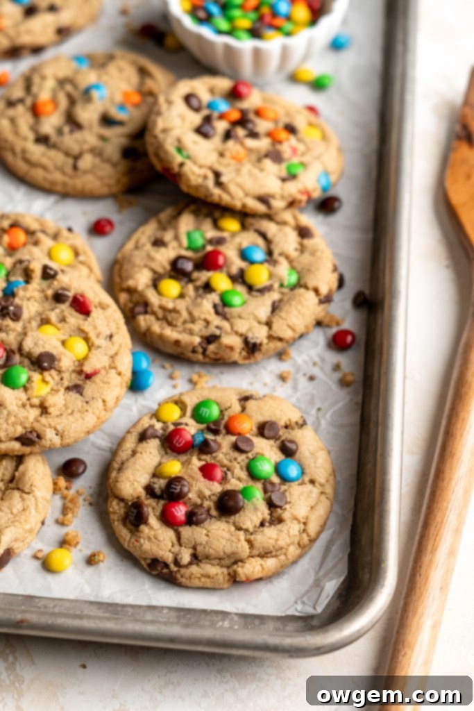 A tray of freshly baked, golden brown peanut-free monster cookies, still warm and inviting.